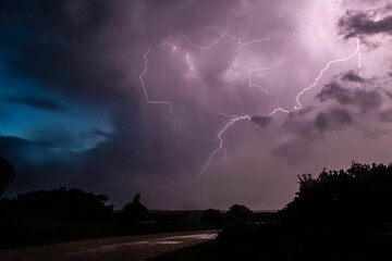 Low angle shot of a striking purple lightning sky in the dark
