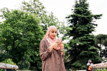 Fototapeta premium Happy Muslim Woman Using Cellphone