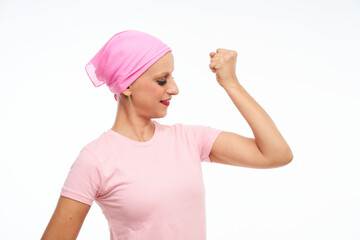 Fototapeta na wymiar portrait of a woman with cancer with a pink scarf on her head, gesticulating with strength