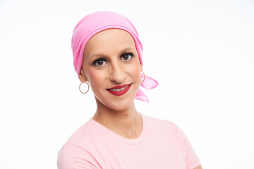 portrait of optimistic woman suffering from cancer with pink head scarf