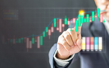 Businessman wearing a black suit pointing high graph to tell interest finance banking, economy, stock, market, oil, gas, petroleum, concept, selective focus, close-up Copy space, blur background