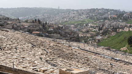 Fototapeta premium View from above over Jerusalem fortress and wall with the cemetery from Mount of Olives in foreground. Landmark landscape view of this city from Israel.