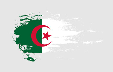 Grunge brush stroke flag of Algeria with painted brush splatter effect on solid background