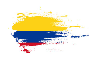 Grunge brush stroke flag of Colombia with painted brush splatter effect on solid background
