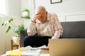 Concerned sad elderly man feeling stressed about his finances and pension - obrazy, fototapety, plakaty