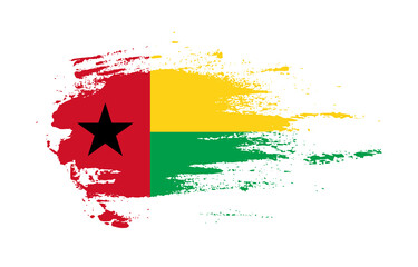 Grunge brush stroke flag of Guinea-Bissau with painted brush splatter effect on solid background