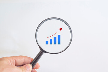 Analysis chart showing growth in a magnifying glass.
inflation analysis idea concept.
