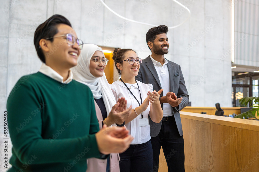 Wall mural multi-ethnic business group applauding in office