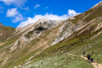 Beautiful mountain scenery. River, valley, snow, blue sky, white clouds. In-depth trip on the Sonamarg Hill Trek in Jammu and Kashmir, India