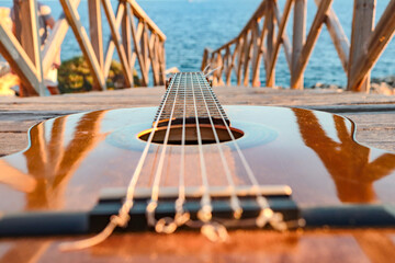 classical guitar close-up with the sea in the background
