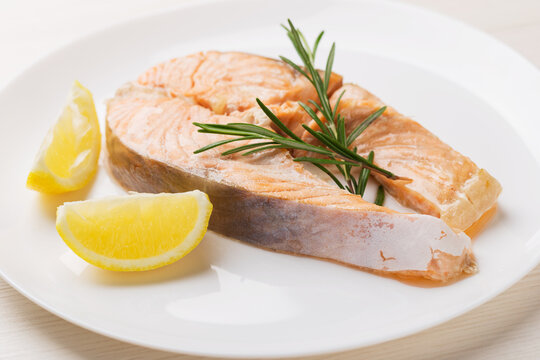 Salmon Served With Rosemary, Fresh Lemon On White Dish. Healthy Eating. Mediterranean Cuisine. Pescetarianism.