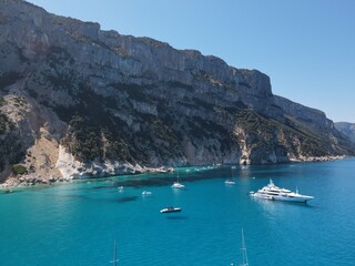 Fototapeta premium Aerial view of the famous Cala Goloritze in Orosei Gulf, East Sardinia, Italy. Drone and birds eye of clear and crystalline water over the top of Punta Salinas, Sardinia (Sardegna).