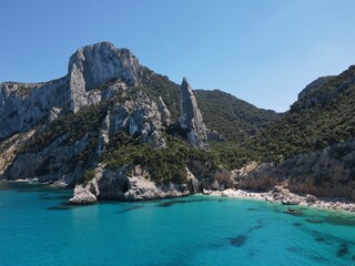 Fototapeta premium Aerial view of the famous Cala Goloritze in Orosei Gulf, East Sardinia, Italy. Drone and birds eye of clear and crystalline water over the top of Punta Salinas, Sardinia (Sardegna).