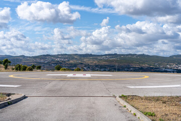 Helipad. Helicopter Landing Pad near emergency hospital in Portugal with cloud sky and city on background