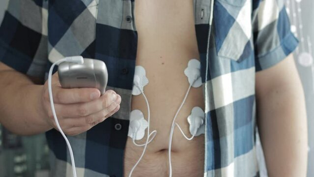 A modern electrical device with electrodes for relieving tension and muscle pain. Fat burning and weight loss.