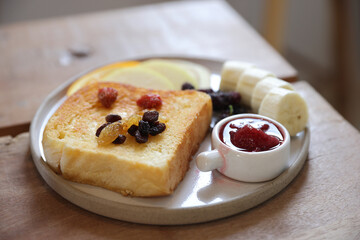 Toast breakfast with dried berry and jam on wood background
