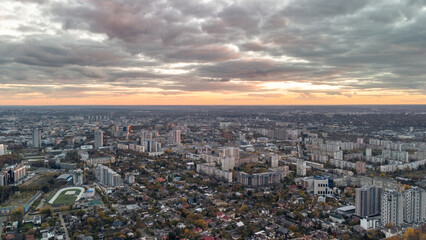 Fototapeta na wymiar Aerial autumn city panorama view with epic cloudscape. Residential district buildings in evening light. Kharkiv, Ukraine