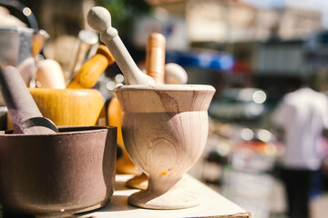 A wooden mortar and pestle used for grinding spices and herbs 