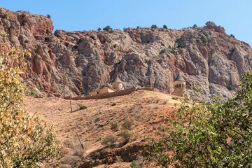 Fototapeta premium Red rocks among the mountain landscape in the mountains of Armenia.