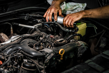 Fototapeta na wymiar Close up of auto mechanic repairing car engine in car service
