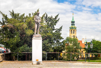 Statue, monument to Edvard Benes on Loreto Square and tower of Loreta Monastery church, Prague,...