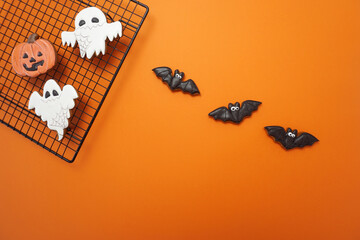 Halloween gingerbread cookies are on an orange background