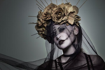 The beautiful girl with marbled skin in a wreath of golden roses with thorns and a black veil....