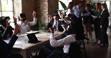 Diverse business people wearing virtual reality goggles inside creative office - Metaverse and technology concept - Powered by Adobe