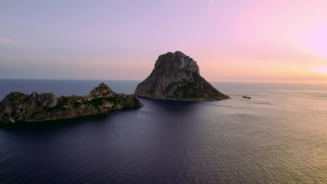 Aerial view of Es Vedra Ibiza during sunset. Showing ocean and clear skies. Cinematic 4K