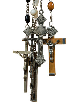 Close-up of a group of metal and wooden crucifixes and rosary beads isolated on transparent background, photography, png.