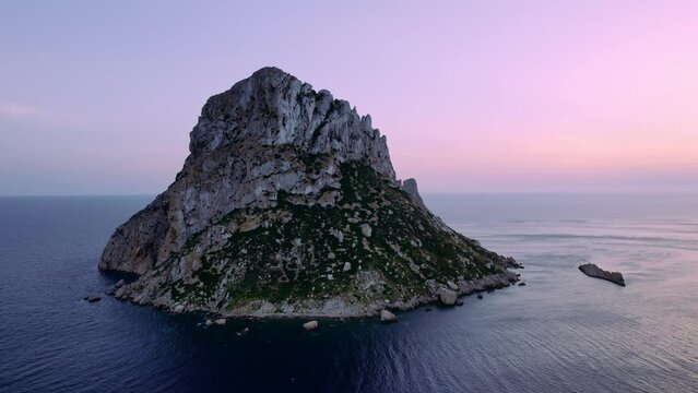 Aerial view of Es Vedra Ibiza during sunset. Showing ocean and clear skies. Cinematic 4K