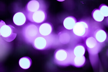 Abstract multicolored bokeh on a dark background. Beautiful background with purple bokeh on a black...
