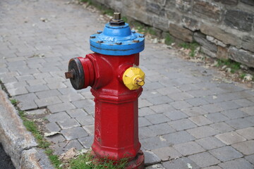 Fototapeta na wymiar Colorful fire extinguisher in Quebec City, Canada