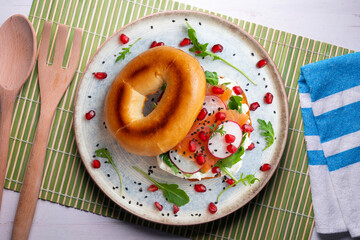 Toasted baggels with salmon, cream cheese, arugula, radishes and pomegranates.
