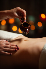 Professional massege woman client working at spa center. Young beautiful woman relaxing during full body massage at luxury resort wellness wellbeing pampering skin