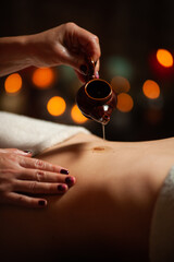 Professional massege woman client working at spa center. Young beautiful woman relaxing during full body massage at luxury resort wellness wellbeing pampering skin