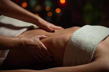 Obraz premium Professional massege woman client working at spa center. Young beautiful woman relaxing during full body massage at luxury resort wellness wellbeing pampering skin