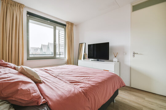Soft bed and commode in modern light bedroom