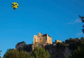 hot air balloon above the castle of Beynac in the Dordogne area in France