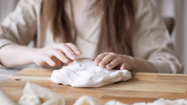 Handcraft woman master modeling cold porcelain, hands pressure dough porcelain, Girl sculpts from porcelain, hobby for the soul scandinavian and boho style interior decor