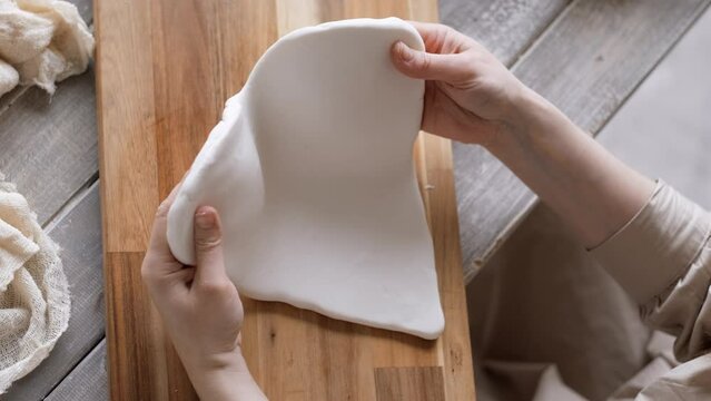 Handcraft woman master modeling cold porcelain, hands pressure dough porcelain, Girl sculpts from porcelain, hobby for the soul scandinavian and boho style interior decor