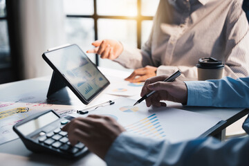 Teamwork with business people analysis cost graph on desk at meeting room, teamwork concept.