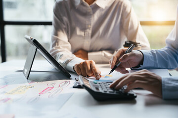 Teamwork with business people analysis cost graph on desk at meeting room, teamwork concept.