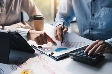 Teamwork with business people analysis cost graph on desk at meeting room, teamwork concept.