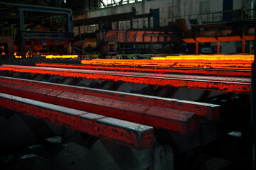 Steel manufacturing process,steel bars are taken out of the furnace to be processed. Photographed in ambiental light, low light.