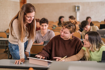 University professor solving the doubts of her students in the multicultural classroom