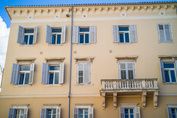 old, colorful houses and narrow streets in the center of the old town of Pula. In the background, port oddities