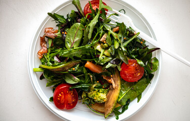 Vegetable salad with salmon pieces.