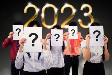 Business people with question mark and 2023 number