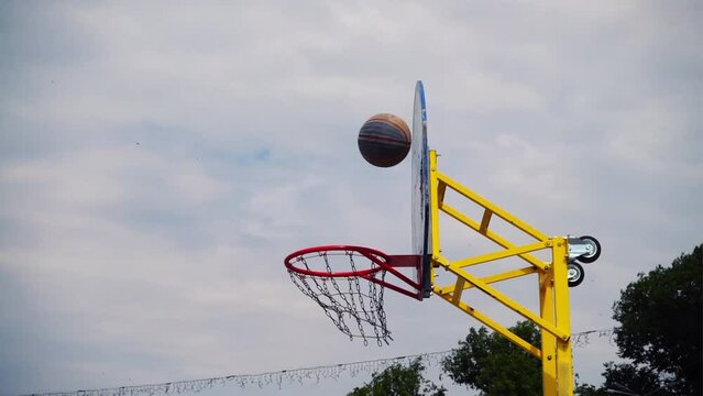 Streetball. The ball flies to a ring. Slow motion.